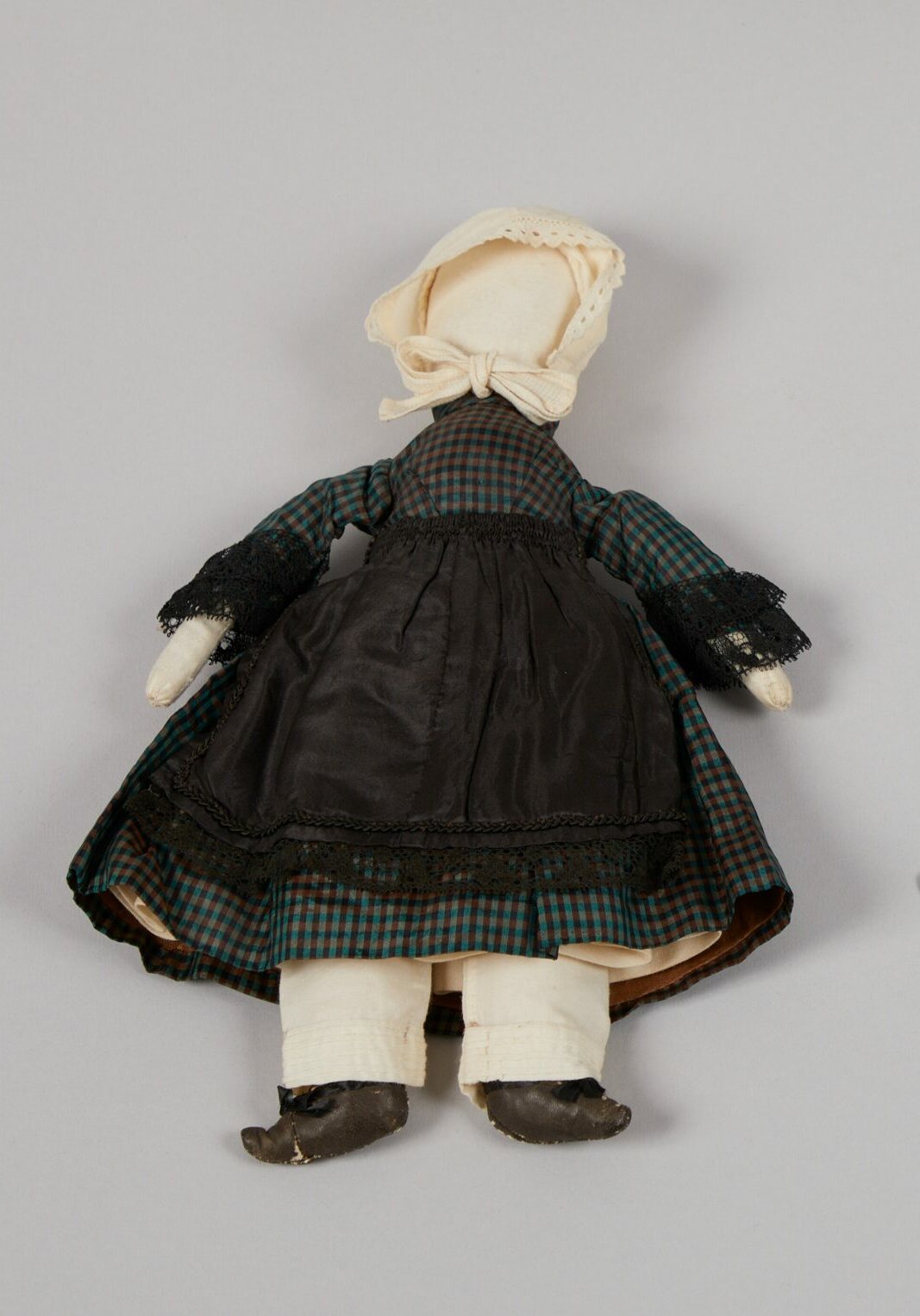 Cloth doll with plaid dress.